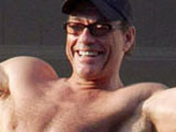 Jean-Claude Van Damme waving to the fans below from his hotel room balcony at the Carlton Palace during the 61st Cannes Film Festival