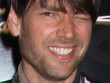 Blur bassist and cheesemaker, Alex James, smiles for cameras at a fashion launch at Somerset house.
