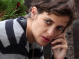 Samantha Ronson sitting on a bench and talking on her phone in Soho. New York City.