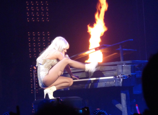 Lady GaGa appears to set fire to her piano during her performance of 