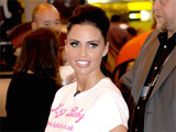 Katie Price walking through the NEC as she promotes her new baby clothing range