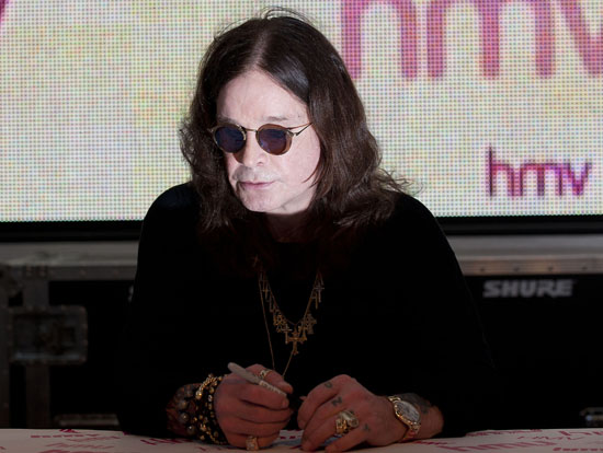 ozzy osbourne signs copies of