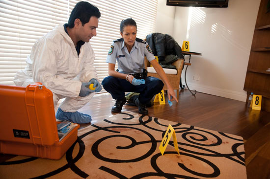 Charlie Buckton examines a crime scene in Home and Away