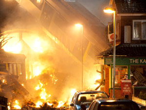The residents look on in horror after the tram comes crashing off the viaduct