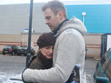 Carl hugs a tearful Nicola as they show mugshots of Jimmy to people