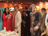 As they are arguing, the ceiling of the restaurant suddenly gives way.