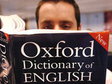 A man reading the Oxford English Dictionary