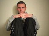 Aaron sits in his pilice cell, grieving and terrified