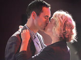 Their banter leads to a passionate kiss