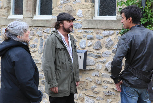 Cain Dingle (Jeff Hordley) punches Zak Dingle (Steve Halliwell) while Lisa Dingle (Jane Cox) watches on