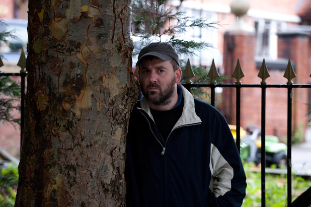 John watches from afar as Fiz is lead into court