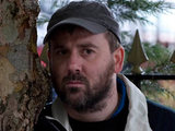 John watches from afar as Fiz is lead into court