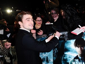 Daniel Radcliffe signs autographs for fans at the world premiere of The Woman in Black, at The Royal Festival Hall
