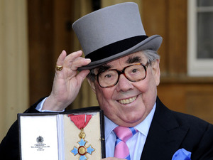 Queen Elizabeth II presents Ronnie Corbett with his Commander of the British Empire (CBE) medal during an Investiture ceremony at Buckingham Palace