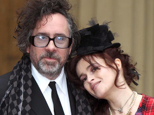 Helena Bonham Carter and her husband Tim Burton pose with her Commander of the British Empire (CBE) medal, after an Investiture ceremony at Buckingham Palace
