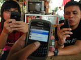 Blackberry users chat with their blackberry at Cafe Vendor In Jakarta, Indonesia