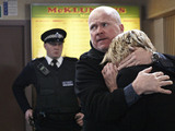 Phil comforts Shirley as the police begin their questioning.