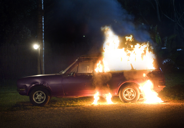 Michael's beloved car burns after Natasha sets fire to it.