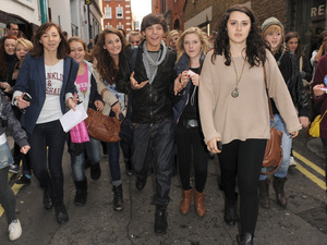 X Factor finalist Louis Tomlinson from boy band One Direction is mobbed by fans as he goes shopping in Covent Garden.
London