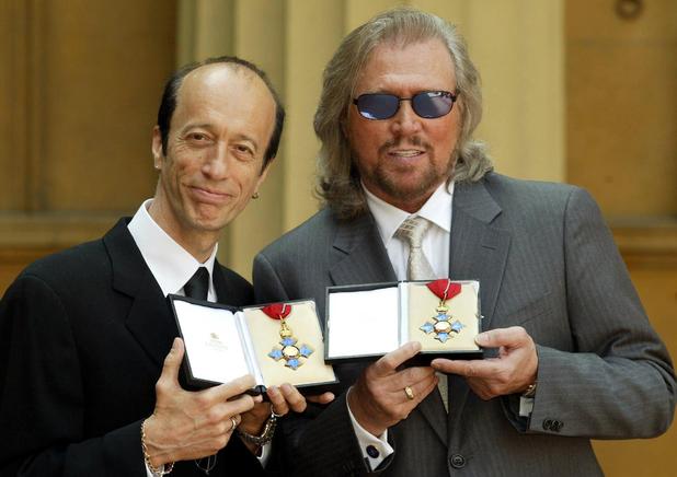 Robin and Barry Gibb hold their CBE's
