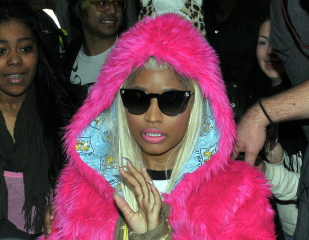 Nicki Minaj is greeted by hundreds of fans at Heathrow airport.