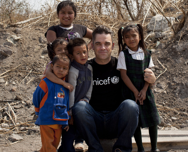 Soccer Aid England captain Robbie Williams meets children living in slums in Mexico City