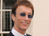 Robin Gibb, founding member of the Bee Gees, unveils a plaque honouring the work of the Bee Gees at 67 Brook Street, central London