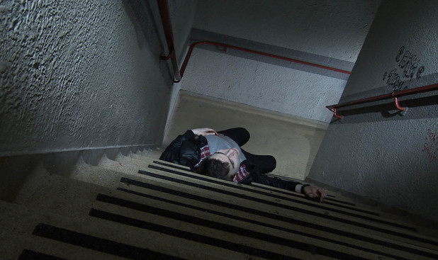 Joel lays unconscious.