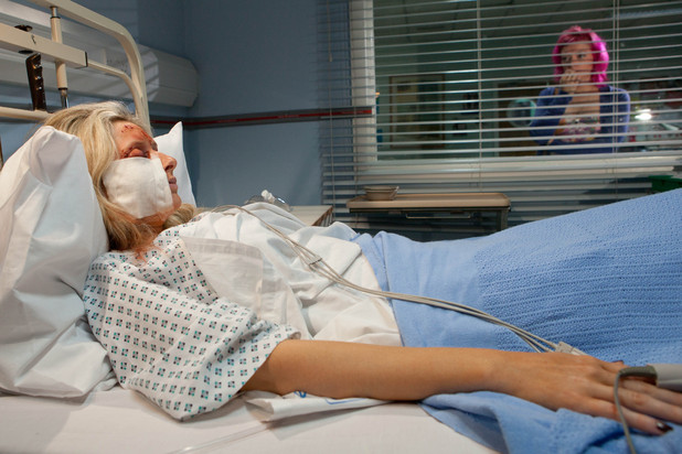 Michaela looks on as Carmel lies in her hospital bed.