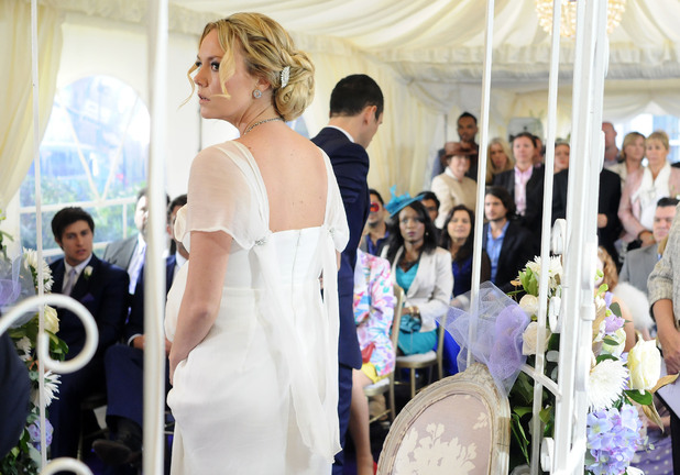 Janine is bewildered as Michael takes her back down the aisle.