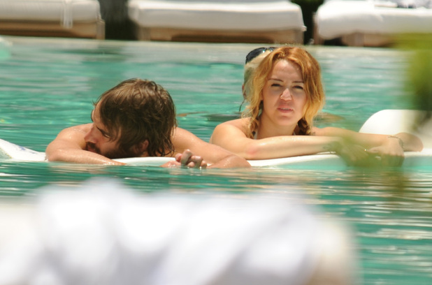 Miley Cyrus and Cheyne Thomas
spend some time relaxing at the pool together
Miami, Florida