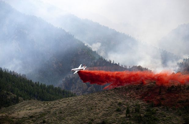 A helicopter drops retardant 