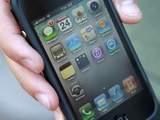 Daniel Rudofsky, 21, holds his new iPhone after standing in line outside the Apple Store in the Georgetown neighborhood of Washington, on Thursday, June 24, 2010