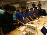 Staff help customers activate their new iPhone 3GS at an Apple store in London, Friday, June 19, 2009, as Apple launched the sale of the new iPhone in Britain