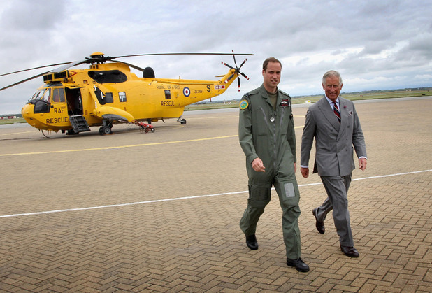The Duke of Cambridge shows the Prince of Wales one of the Sea King helicopters he captains as Prince Charles visits RAF Valley on Anglesey, during his annual summer tour of Wales.