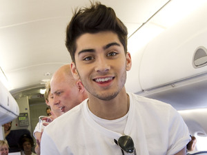 Zayn Malik gets to grips with the snacks trolley.