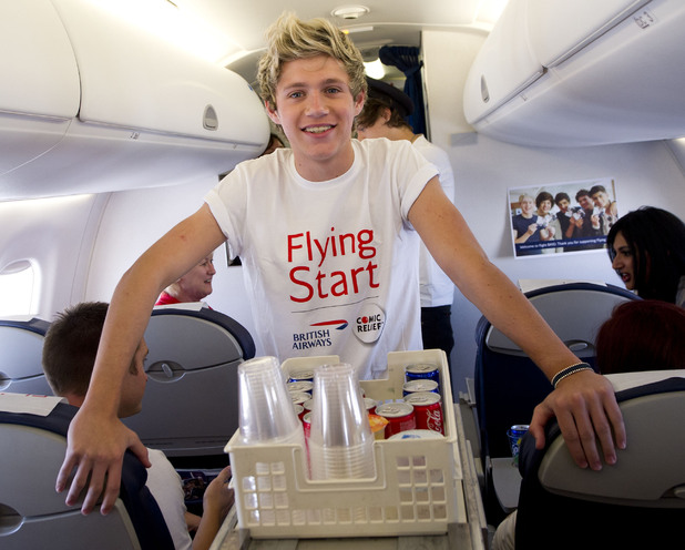 Niall Horan serves drinks on board the flight.