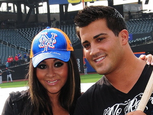 A pregnant Nicole 'Snooki' Polizzi and her fiance Jionni LaValle pose with baseball bats after meeting the New York Mets baseman David Wright at Citi Field, New York