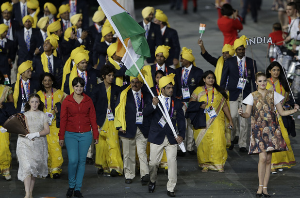 India's Sushil Kumar carries the flag during the Opening Ceremony at the 2012 Summer Olympics and is invaded by a gatecrasher.