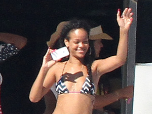 Smiling Rihanna chats to friends onboard a yacht while holidaying in Saint-Tropez, France - 21.07.12