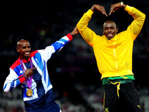 Mo Farah and Usain Bolt celebrate their gold medals and trade each other's poses on the podium.