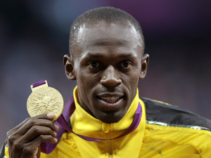 Usain Bolt with his 100m gold medal from London 2012 (PA green label)