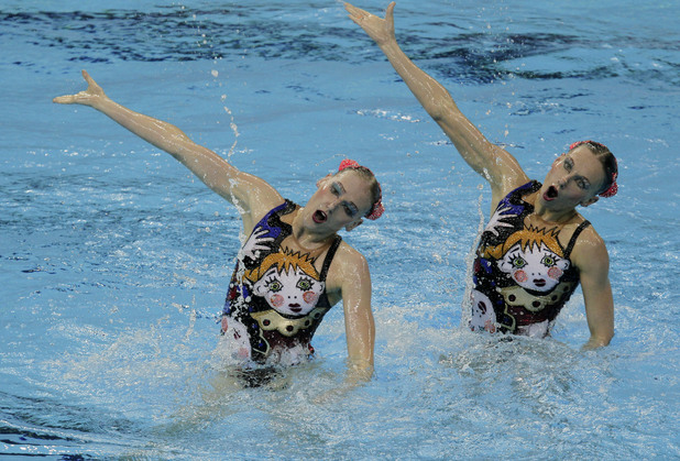 Gold medalists Natalia Ishchenko and Svetlana Romashina from Russia compete during the women's duet synchronized swimming final at the Aquatics Centre