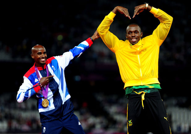 Mo Farah and Usain Bolt celebrate their gold medals and trade each other's poses on the podium.