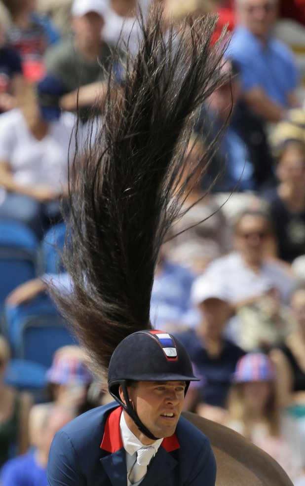 Simon Delestre of France rides his horse Napoli Du Ry in the equestrian individual jumping competition, at the 2012 Summer Olympics