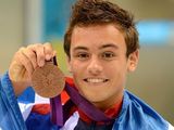 Tom Daley celebrates his bronze medal.