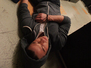 Ryan lies on the floor unconscious after being attacked by Rob