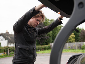 Walker looks inside the boot