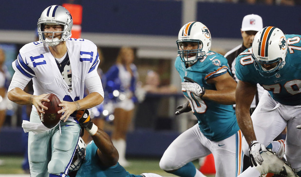 Dallas Cowboys quarterback Rudy Carpenter (11) is tackled by Miami Dolphins defensive tackle Kheeston Randall (97) during the second half of a preseason NFL football game