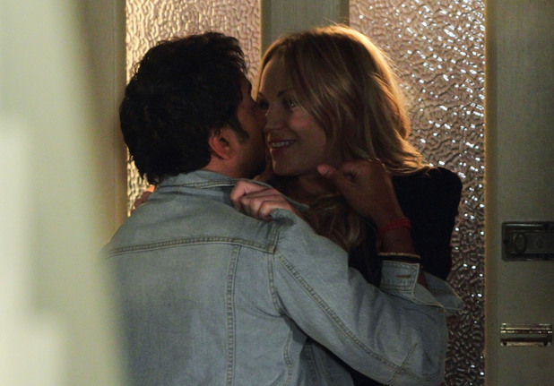 Roxy and AJ share a drunken kiss in the hallway of the Masood's.
